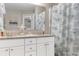 Bathroom with double sink vanity, granite countertops, white cabinetry, and beach-themed shower curtain at 500 Willow Greens Dr. # 500-G, Conway, SC 29526