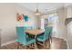 Light-filled dining room features a wooden table with blue chairs and colorful artwork at 500 Willow Greens Dr. # 500-G, Conway, SC 29526