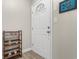 Bright entryway featuring a white door, decorative wall art, and a wooden shelf for storage at 500 Willow Greens Dr. # 500-G, Conway, SC 29526