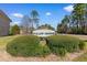 Inviting entrance to Willow Greens, a deed-restricted community, framed by lush greenery and a clear blue sky at 500 Willow Greens Dr. # 500-G, Conway, SC 29526