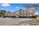 Attractive brick apartment building featuring well-maintained landscaping and an ample parking lot on a bright, sunny day at 500 Willow Greens Dr. # 500-G, Conway, SC 29526