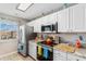 Bright kitchen features white cabinetry, stainless steel appliances, and granite countertops under recessed lighting at 500 Willow Greens Dr. # 500-G, Conway, SC 29526