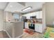 Well-lit kitchen with stainless steel appliances, white cabinets, and a breakfast bar with attractive countertops at 500 Willow Greens Dr. # 500-G, Conway, SC 29526