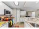 Bright kitchen featuring white cabinets, stainless steel appliances, and attractive countertops with bar seating at 500 Willow Greens Dr. # 500-G, Conway, SC 29526