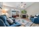 Inviting living room features a vaulted ceiling, ceiling fan, fireplace with stone surround, and comfortable seating at 500 Willow Greens Dr. # 500-G, Conway, SC 29526