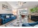 Inviting living room featuring a comfortable blue sofa, a stone fireplace, and an open doorway to an office space at 500 Willow Greens Dr. # 500-G, Conway, SC 29526