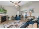 Bright living room featuring a fireplace, ceiling fan, wood flooring, and comfortable blue furniture at 500 Willow Greens Dr. # 500-G, Conway, SC 29526