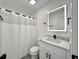 A full bathroom featuring white cabinets, black hardware, and a lighted mirror at 5000 Windsor Green Way # 204, Myrtle Beach, SC 29579