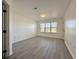 A bedroom with a window, light gray flooring, and white walls at 5000 Windsor Green Way # 204, Myrtle Beach, SC 29579