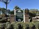 Windsor Green at Waterford Plantation entrance sign with lush landscaping and brick columns at 5000 Windsor Green Way # 204, Myrtle Beach, SC 29579