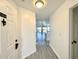 Inviting entryway with new gray flooring leading to a bright, modern open-concept layout at 5000 Windsor Green Way # 204, Myrtle Beach, SC 29579
