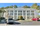 Condo building featuring white columns, multiple balconies, and well-maintained landscaping at 5000 Windsor Green Way # 204, Myrtle Beach, SC 29579