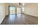 Living room with sliding doors to balconies, wood-look flooring, and white walls at 5000 Windsor Green Way # 204, Myrtle Beach, SC 29579