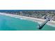 Coastal community aerial view featuring blue water, pier, beach, and colorful houses at 512B S Ocean Blvd., Surfside Beach, SC 29575