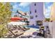 Relaxing backyard with a beautiful in-ground pool, lounge chairs, umbrellas, and white fencing at 512B S Ocean Blvd., Surfside Beach, SC 29575