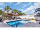 Inviting backyard featuring an in-ground pool, lounge chairs, red umbrellas, and privacy fencing at 512B S Ocean Blvd., Surfside Beach, SC 29575