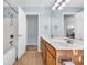 Bathroom with double vanity, tile floors, shower/tub combination, and open doorway at 512B S Ocean Blvd., Surfside Beach, SC 29575