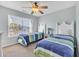 Charming bedroom with two twin beds, soft carpet, a ceiling fan and bright window at 512B S Ocean Blvd., Surfside Beach, SC 29575