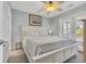 Bright bedroom features a queen bed, soft carpet, a ceiling fan and bright window at 512B S Ocean Blvd., Surfside Beach, SC 29575