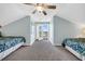 Light-filled bedroom with ceiling fan and doors leading to a balcony with ocean views at 512B S Ocean Blvd., Surfside Beach, SC 29575