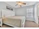 Bright bedroom with a queen bed, soft carpet, a ceiling fan and bright window at 512B S Ocean Blvd., Surfside Beach, SC 29575