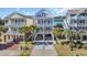 Charming multi-story homes featuring spacious balconies and covered parking spaces with palm tree landscaping at 512B S Ocean Blvd., Surfside Beach, SC 29575