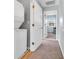 Hallway with stackable washer/dryer and access to another room with natural light at 512B S Ocean Blvd., Surfside Beach, SC 29575
