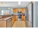 This kitchen features stainless steel appliances, tile floor, granite countertops, and natural wood cabinetry at 512B S Ocean Blvd., Surfside Beach, SC 29575
