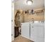 Laundry room equipped with a washer, dryer, shelving and mechanical equipment at 512B S Ocean Blvd., Surfside Beach, SC 29575