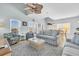 Cozy living room with high vaulted ceiling, fan, neutral-colored couches, and a comfortable rug at 512B S Ocean Blvd., Surfside Beach, SC 29575