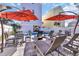 Backyard patio with a pool, sun loungers, and an outdoor dining area with shade umbrellas at 512B S Ocean Blvd., Surfside Beach, SC 29575