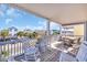 Inviting porch featuring rocking chairs and table with views of the neighborhood and a sunny sky at 512B S Ocean Blvd., Surfside Beach, SC 29575