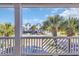 View from the porch towards the street, showcasing palms trees and neighborhood houses at 512B S Ocean Blvd., Surfside Beach, SC 29575