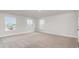 Bedroom featuring neutral carpet and three windows providing natural light at 515 Haven View Way, Murrells Inlet, SC 29576