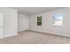 Bedroom with carpeted floors, neutral walls, and two bright windows at 515 Haven View Way, Murrells Inlet, SC 29576