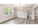 Formal dining room with hardwood floors, large window, modern chandelier, and a view into the kitchen at 515 Haven View Way, Murrells Inlet, SC 29576