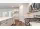 Modern kitchen with white quartz countertops, stainless steel appliances, and a stylish tile backsplash at 515 Haven View Way, Murrells Inlet, SC 29576