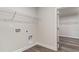 Laundry room with overhead storage and wood-look flooring at 515 Haven View Way, Murrells Inlet, SC 29576
