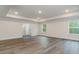 Spacious main bedroom with tray ceiling, hardwood floors, and natural light at 515 Haven View Way, Murrells Inlet, SC 29576