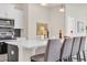 Contemporary kitchen features a breakfast bar with seating, quartz countertops, and stainless appliances at 545 Honeyhill Loop, Conway, SC 29526