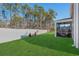 Well-maintained backyard with green lawn, trees, and a screened-in porch at 55 Porch Ln., Pawleys Island, SC 29585