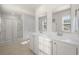Bathroom with double vanity, mirrors, a shower, and neutral-toned tiles at 55 Porch Ln., Pawleys Island, SC 29585