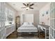 Bedroom featuring a Murphy bed, desk, hardwood floor, ceiling fan and large window at 55 Porch Ln., Pawleys Island, SC 29585