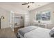 Bright bedroom features a ceiling fan, wood floors, and a decorative console table with a view to the outside at 55 Porch Ln., Pawleys Island, SC 29585