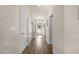Bright hallway with hardwood floors, storage closets, and access to other rooms at 55 Porch Ln., Pawleys Island, SC 29585