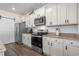 Kitchen featuring white cabinets, stainless steel appliances and a large refrigerator at 55 Porch Ln., Pawleys Island, SC 29585