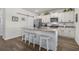 Modern kitchen with granite countertops, white cabinetry, and a spacious island with seating at 55 Porch Ln., Pawleys Island, SC 29585