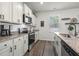 Beautiful kitchen featuring white cabinets, stainless steel appliances, and granite countertops at 55 Porch Ln., Pawleys Island, SC 29585