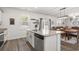Open kitchen with granite island, stainless steel dishwasher and view into the dining and living areas at 55 Porch Ln., Pawleys Island, SC 29585