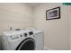 Laundry room with a front-load washing machine and a dryer at 55 Porch Ln., Pawleys Island, SC 29585